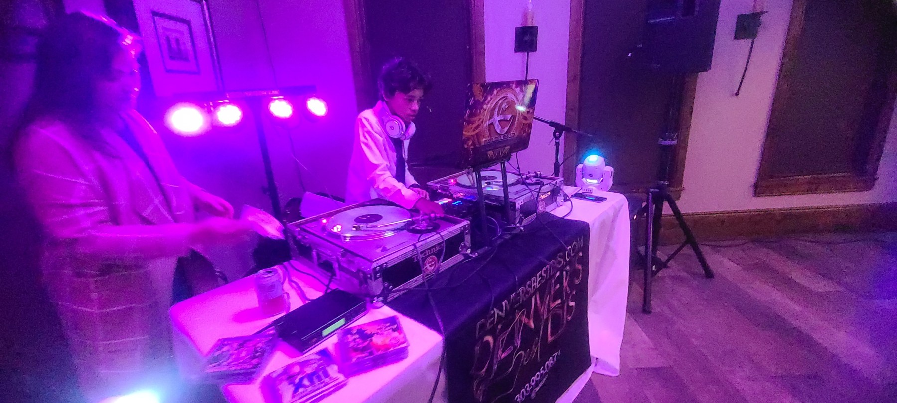 DJ Emerson at Age 11 One of Denver's Best DJs performing at a wedding in Solterra Colorado with his dad DJ Emir. Purple, Blue, and Pink DJ Lighting Technics Turntables with Glow in The Dark Green records White and Silver Beats Pro DJ Headphones Serato DJ system QSC speakers Inteligent Lighting DJ Emir Logo on Asus Laptop
