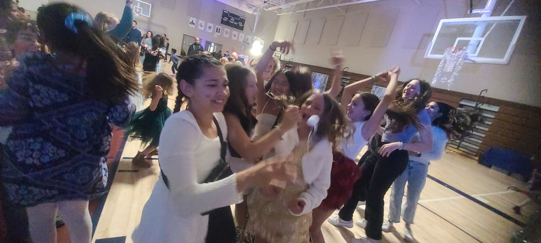 Denver's Best DJs DJ Emir Santana and DJ Emerson get all the kids dancing at the Coyote Hills Winter Snow Ball Dance at Infinity Middle School Cherry Creek. A Bunch of elementary school kids dancing in the gymnasium