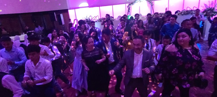 Denver's Best DJs Wedding at Infinity Park Event Center Vietnamese Wedding party dancing witha  big crowd of people on the dancefloor surrounded by lights and projection screens