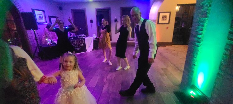 Shawn And Lauren Wedding Vows Renewal Wedding Anniversary Party at The Retreat at Solterra With DJ Emir of Denver's Best DJs and Katie Rose Events Shawn looking on at the photographer as the ladies and kids dance the night away